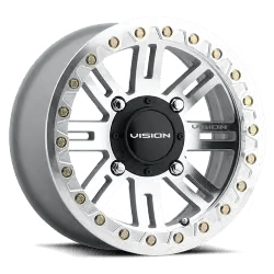 A silver alloy wheel with a black center cap labeled 'Vision,' featuring a multi-spoke design and decorative rivets around the rim.