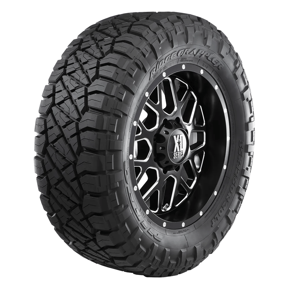 Front-side view of a Ridge Grappler tire on an XD Series wheel with a chrome and black finish.
