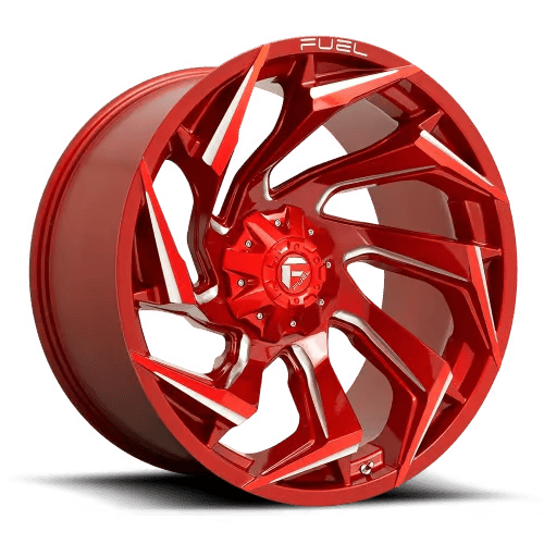 A shiny red alloy wheel with an intricate, angular spoke design, labeled with the brand name 'Fuel.'