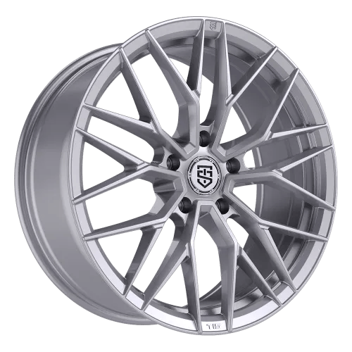 A silver alloy wheel rim with a complex multi-spoke design and the TIS Motorsports brand logo in the center.