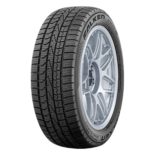A car tire with a detailed tread pattern and silver alloy wheel.