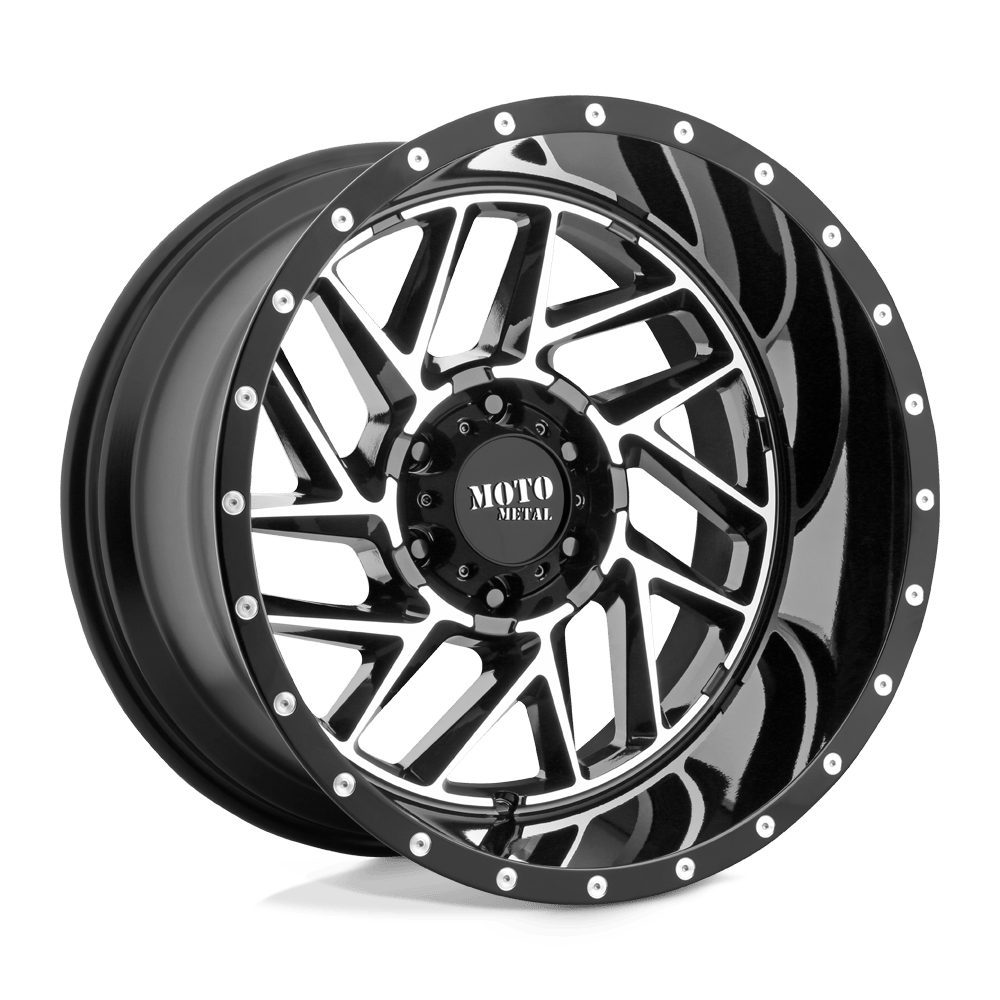 A black and chrome wheel with a geometric spoke design and "Moto Metal" branding on the center cap.