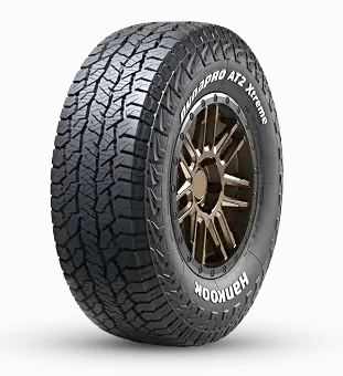Tire with tread pattern, branded "Hankook Dynapro AT2 Xtreme," on a metal wheel rim.