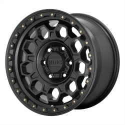 A black alloy wheel with a geometric design and multiple bolts around the rim.