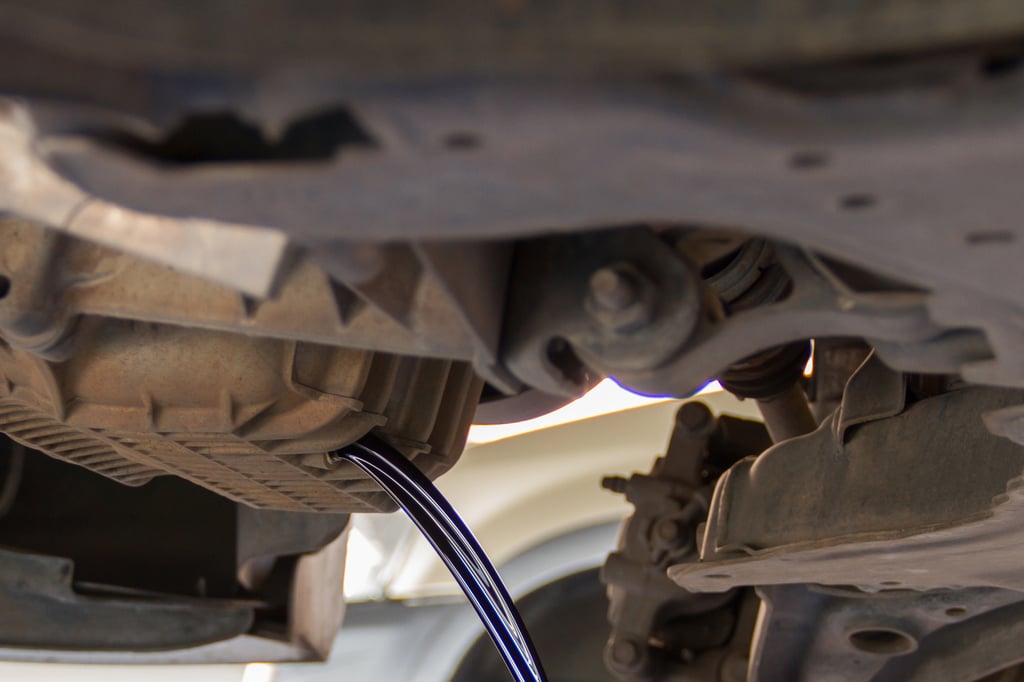 Oil draining from a car's engine.