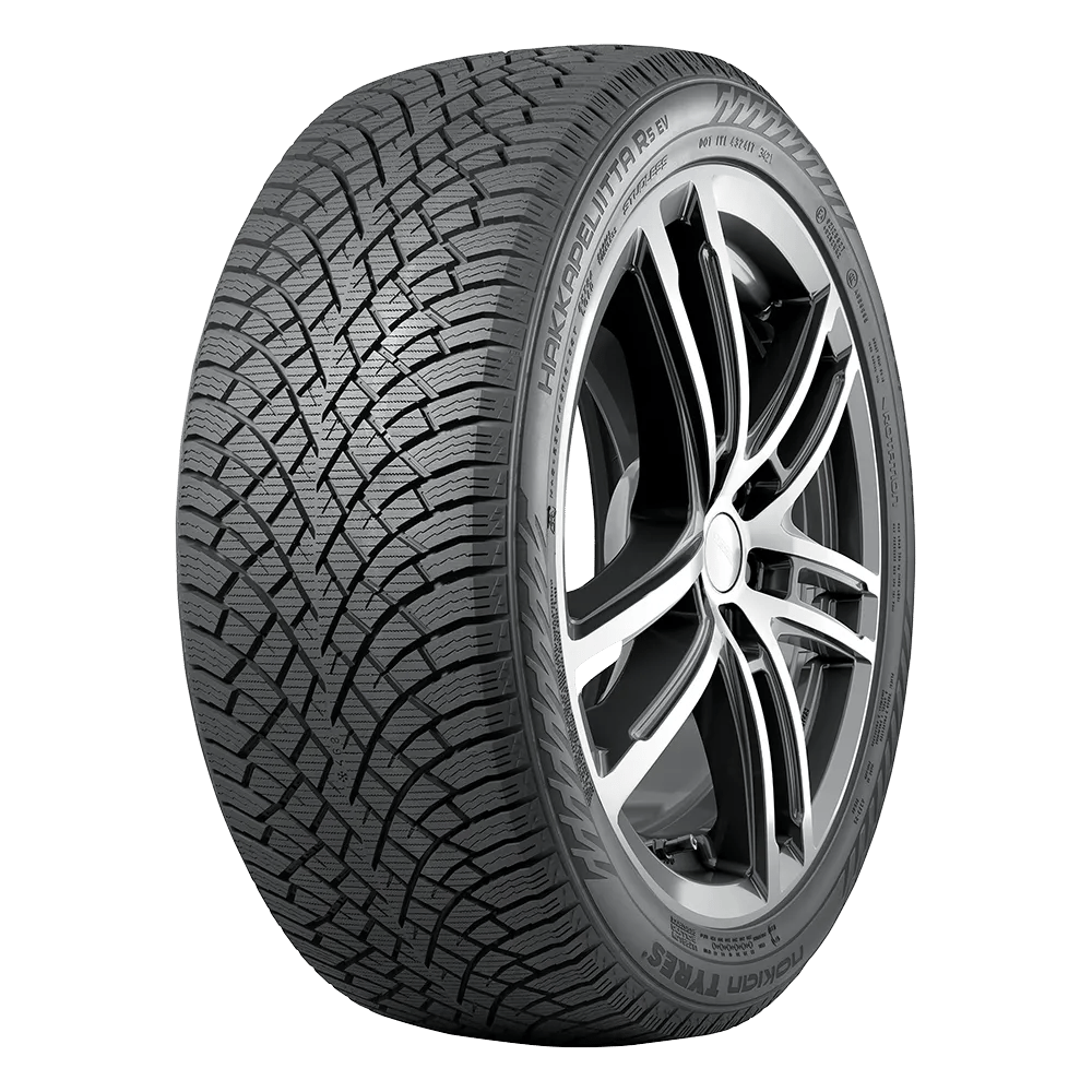 A winter car tire with a detailed tread pattern designed for improved grip, showing a chrome-finished wheel hub. The sidewall text reads 'Hakkapeliitta R5 EV' from Nokian Tyres.