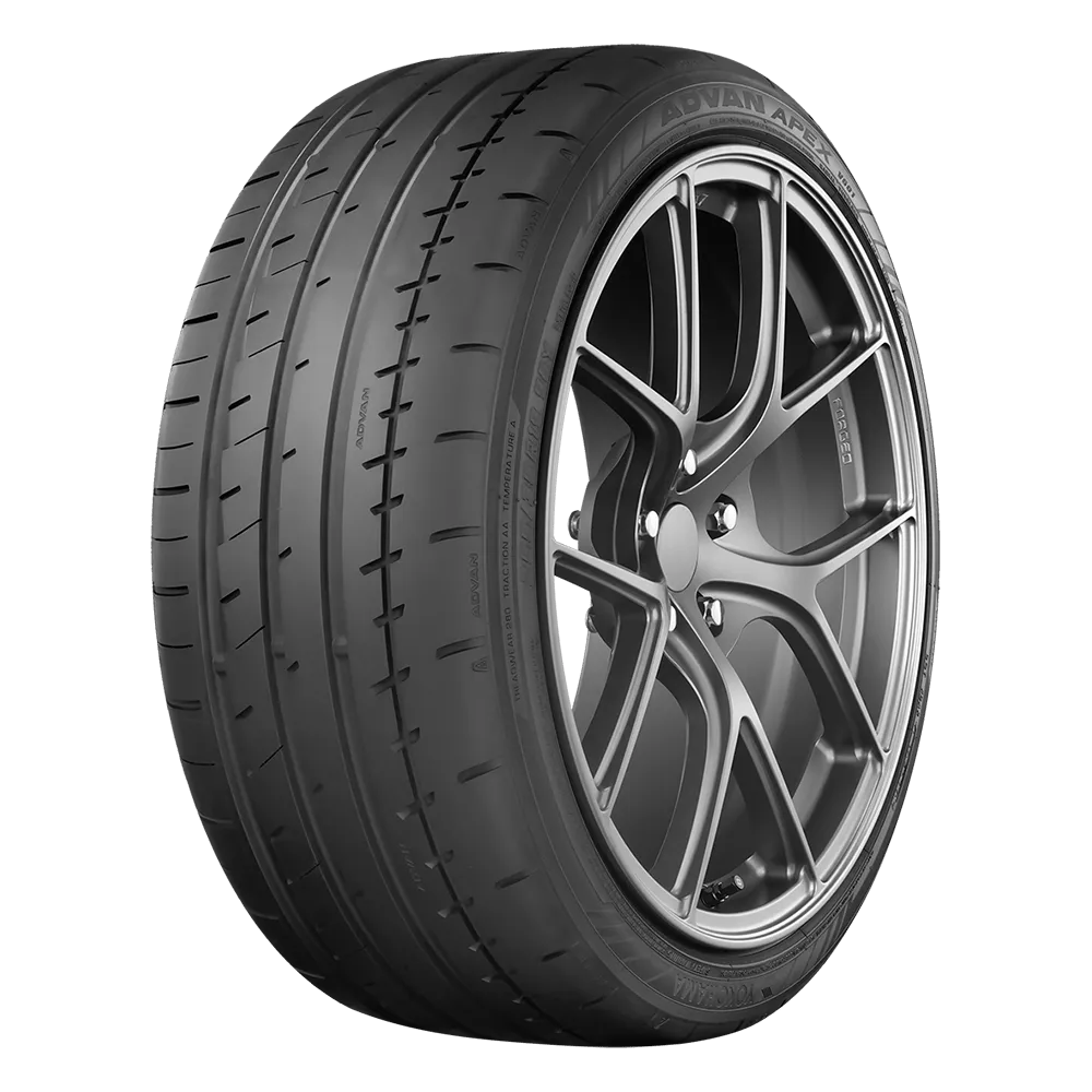 A black yokohama tire mounted on a five spoke v-prong wheel in a dark metal grey finish for a ford mustang