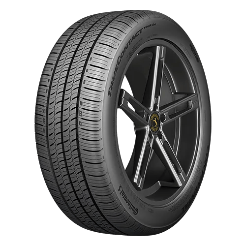 A car tire with a five-spoke alloy wheel, featuring detailed tread patterns and branding visible on the sidewall.