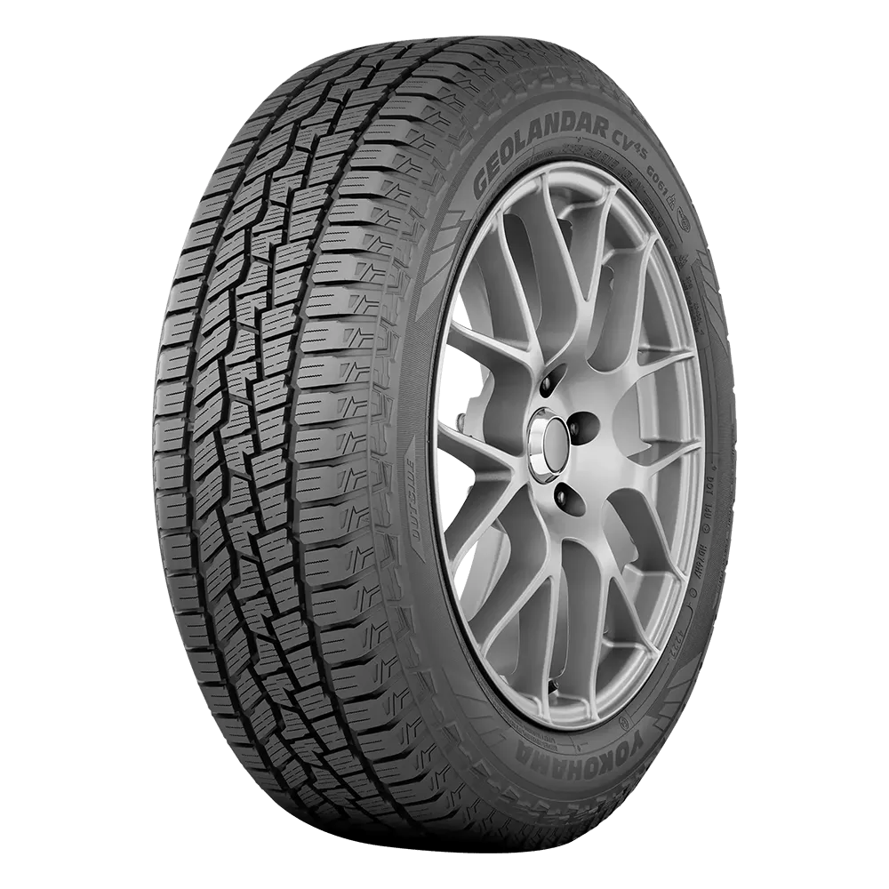 A front side view of a Yokohama Geolander CV tire mounted on a matte chrome finished rim.