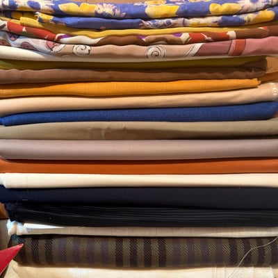 Stack of folded fabrics - Image 1 of 3
