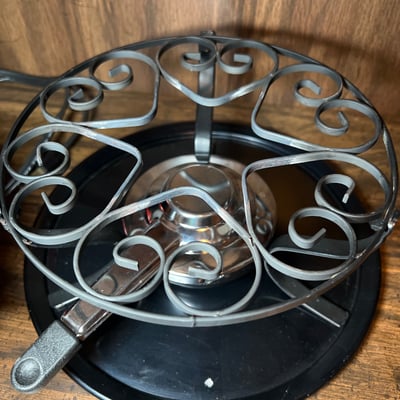 Vintage kitchenware collection: glass segmented serving tray, ceramic pot on burner stand, carved wooden serving piece, and metal scroll trivet - Image 5 of 6