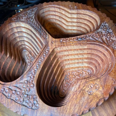Vintage kitchenware collection: glass segmented serving tray, ceramic pot on burner stand, carved wooden serving piece, and metal scroll trivet - Image 6 of 6