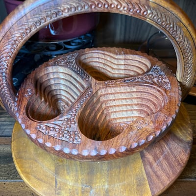 Vintage kitchenware collection: glass segmented serving tray, ceramic pot on burner stand, carved wooden serving piece, and metal scroll trivet - Image 4 of 6