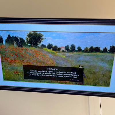 Wall-mounted LG LED TV with mounting hardware, accessories - Image 1 of 5