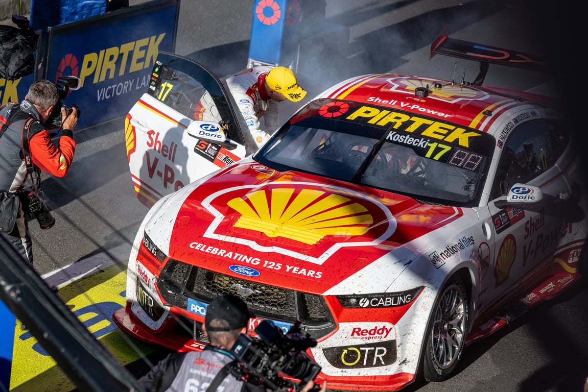Driver exits red and white Shell V-Power Supercar number 17 in Pirtek Victory Lane after a win.