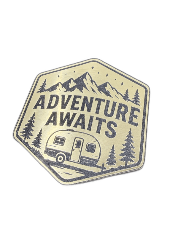 Adventure Awaits hexagonal silver emblem with mountain and pine trees