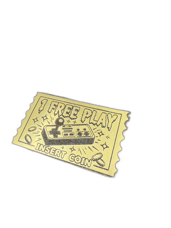 Free Play Insert Coin postage-stamp-shaped gold emblem with arcade controller design