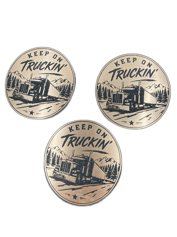 Keep On Truckin circular copper emblem with semi truck silhouette and forest backdrop
