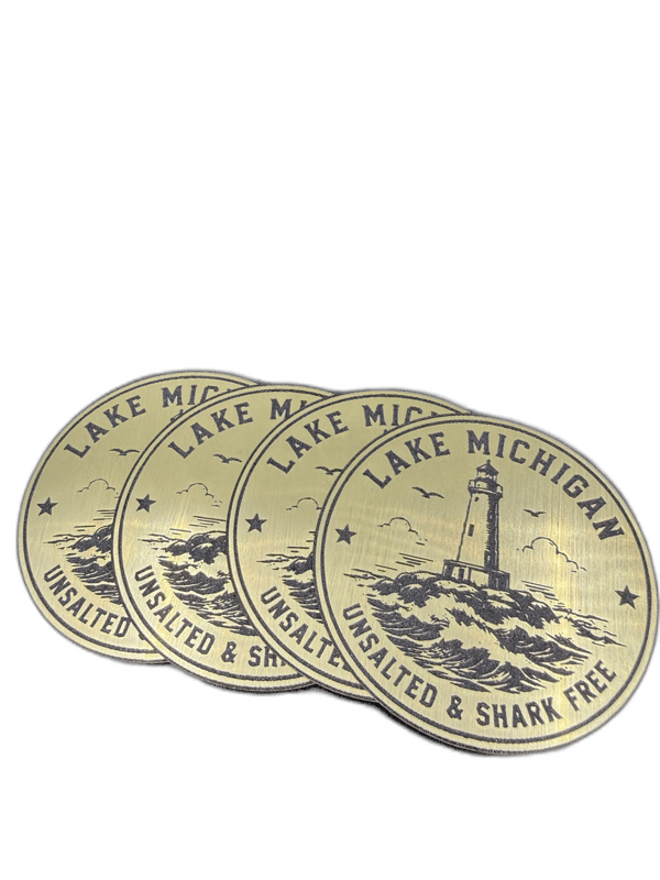 Lake Michigan Unsalted & Shark Free circular gold emblem with lighthouse and waves design
