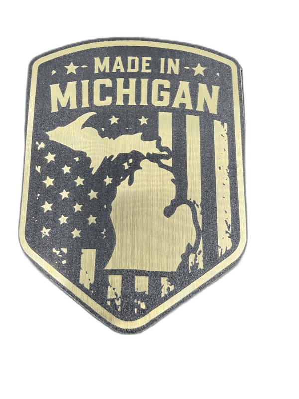 Made in Michigan shield-shaped gold emblem with Michigan map and American flag stars and stripes
