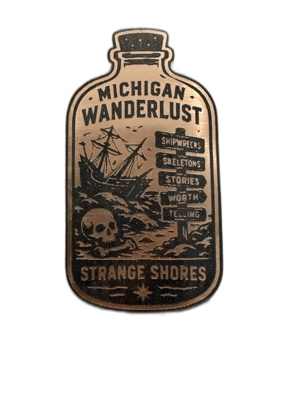 Michigan Wanderlust Strange Shores bottle-shaped copper emblem with shipwreck and lighthouse design