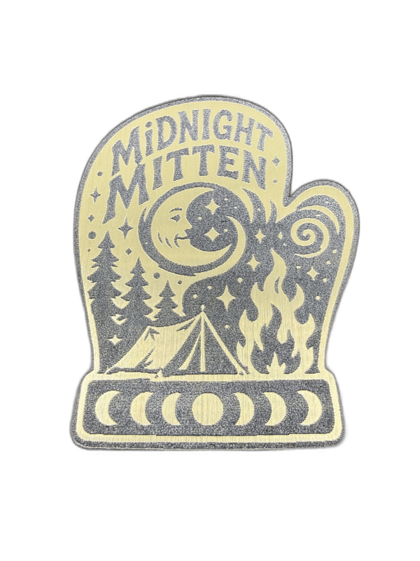 Midnight Mitten mitten-shaped gold emblem with crescent moon, pines, campfire, and tent scene