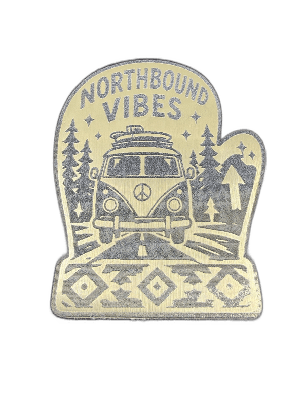 Northbound Vibes mitten-shaped gold emblem with VW van and pine trees scene