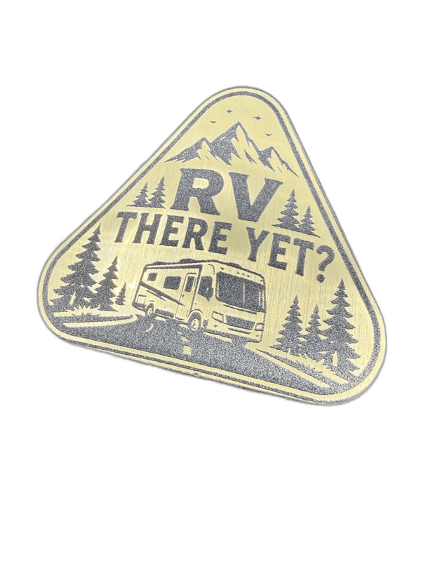 RV There Yet triangular gold emblem with camper trailer and pine trees design