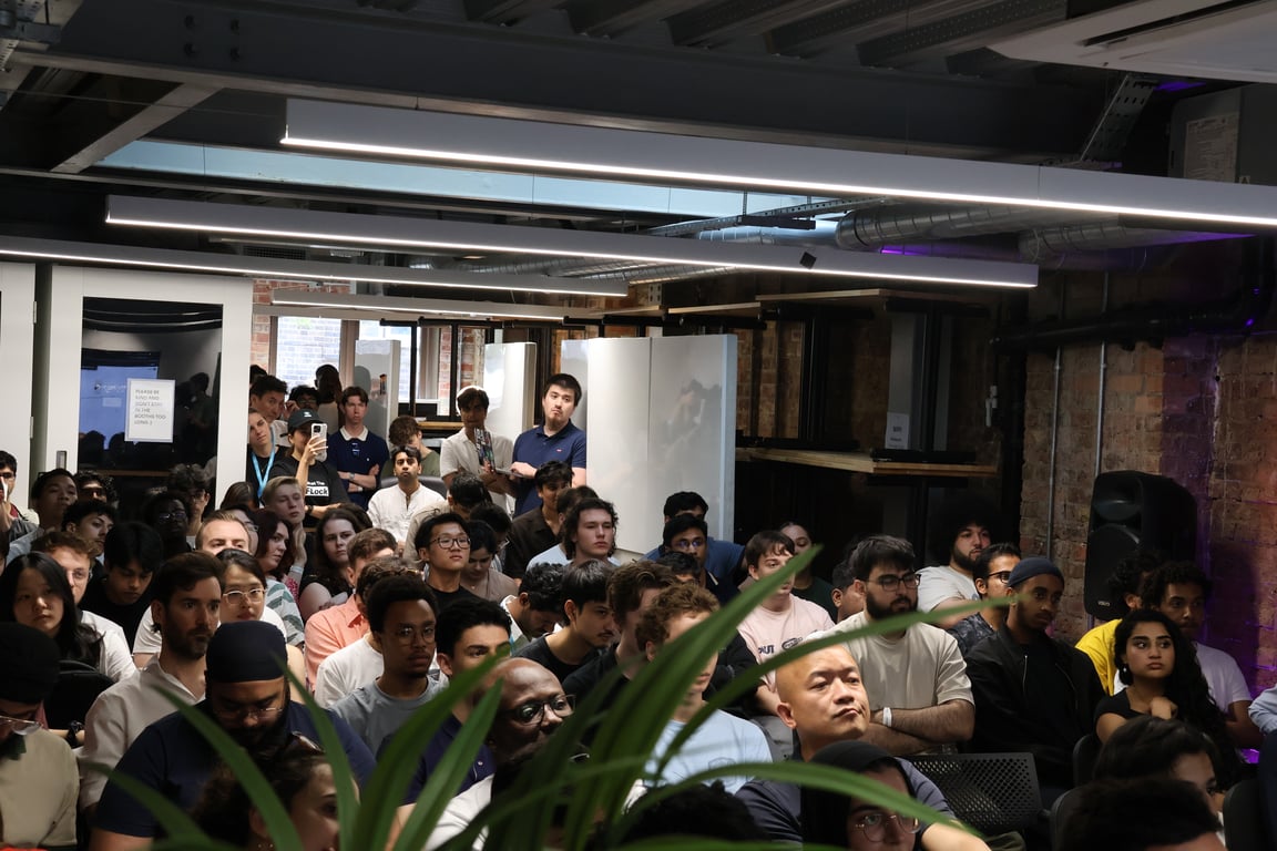 Packed crowd of builders at a Bilt hackathon kickoff