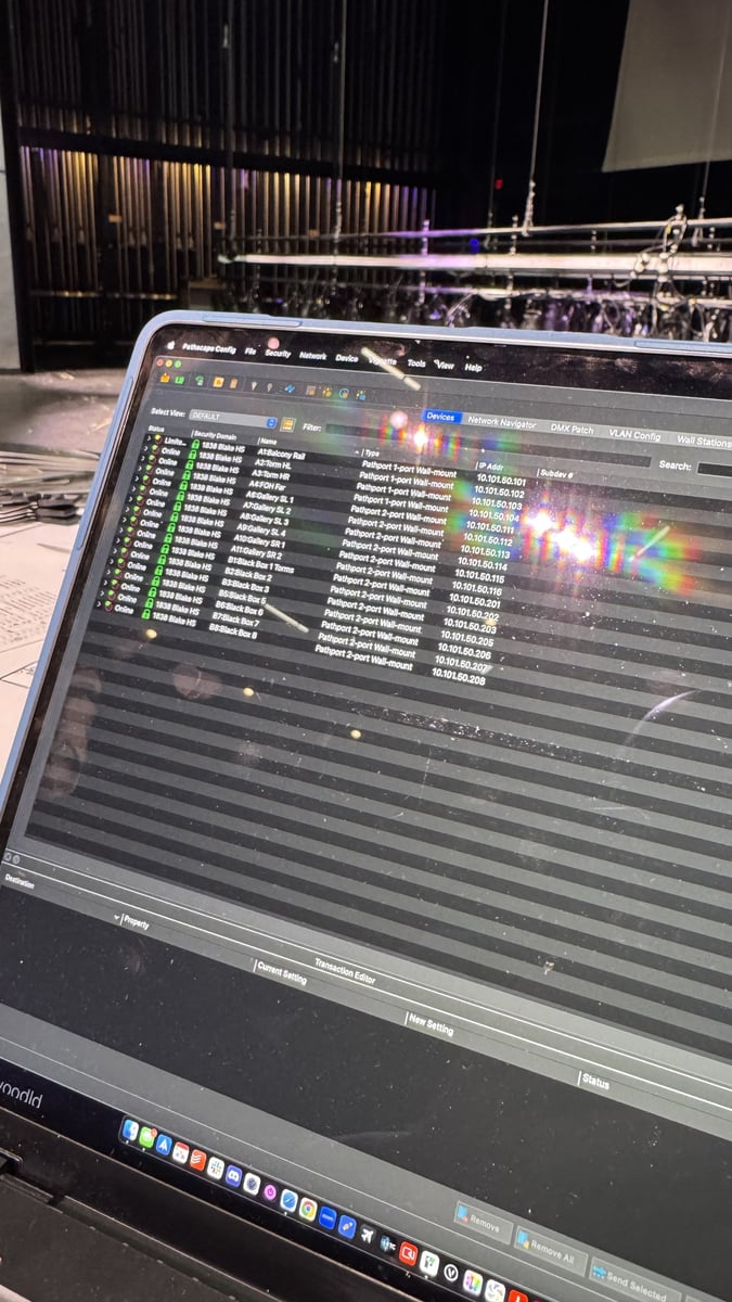 A laptop running Pathscape listing the school's Pathport wall-mount nodes and their IP addresses, with the stage beyond