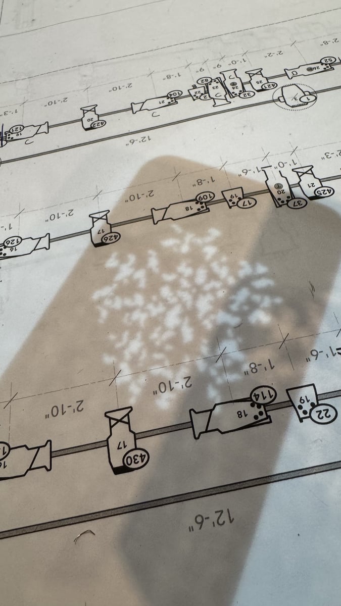 A breakup gobo projected across a printed page of the rep plot during focus
