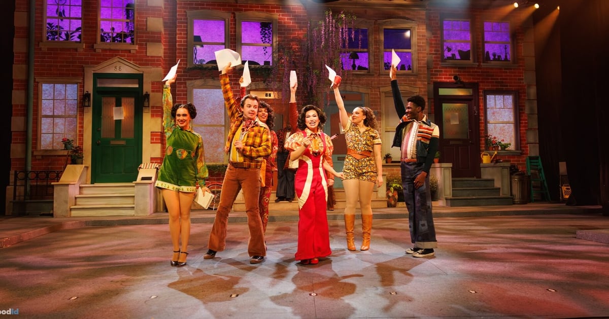 Dancin' In The Street: the full cast lined up across the colorful neighborhood street set.
