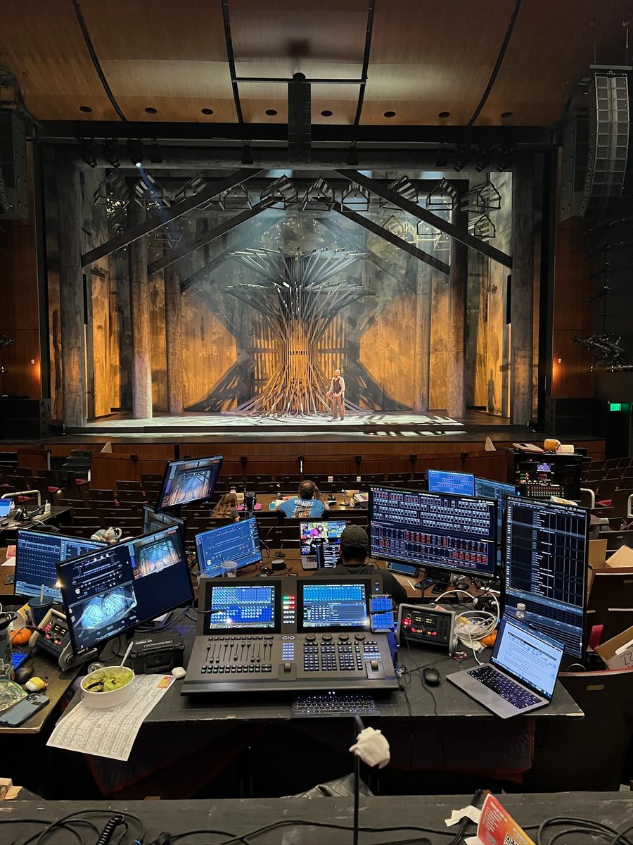 Tech tables in the house with the warm-lit Anatevka village onstage.