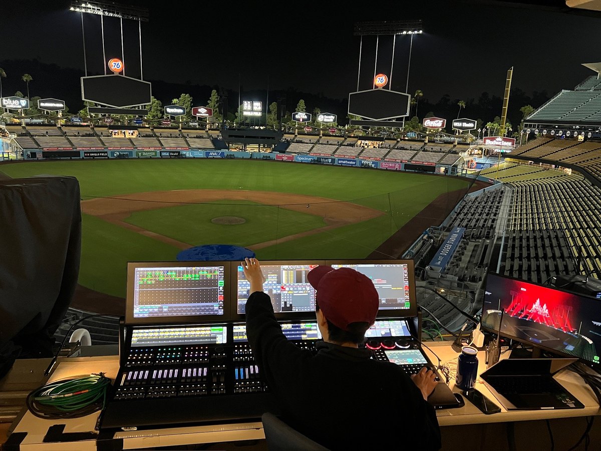 Tech tables in the stands overlooking the field at dusk.