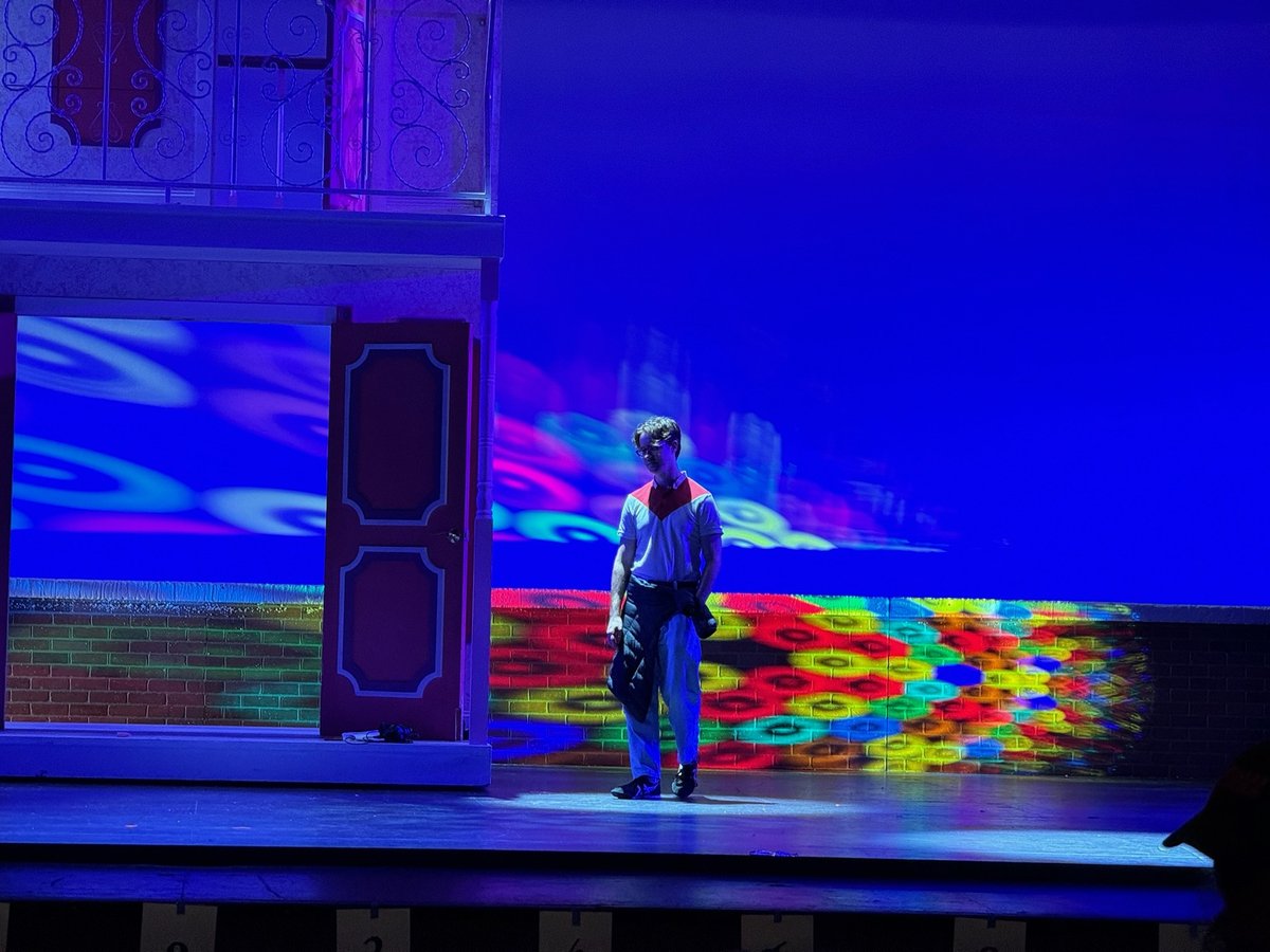 A saturated pink and blue wash across the set during a cue build.