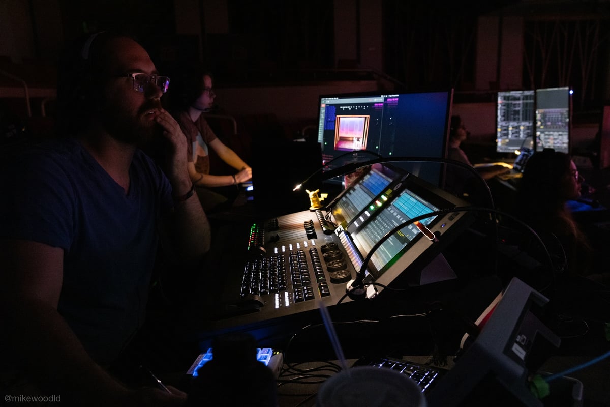 Running the console at the tech table during a tech rehearsal.