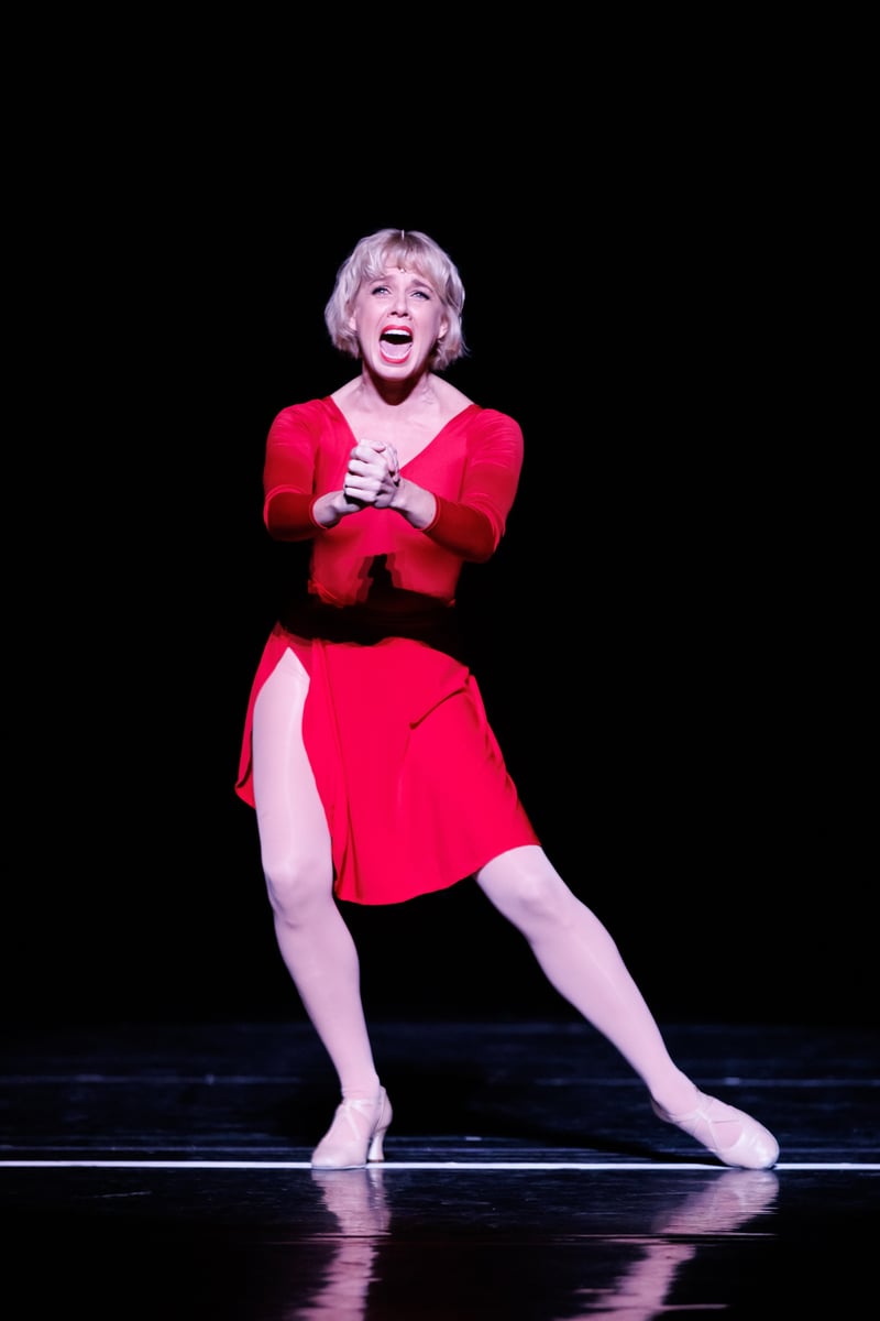 Sarah Bowden as Cassie in the red dress, mid-song during The Music and the Mirror