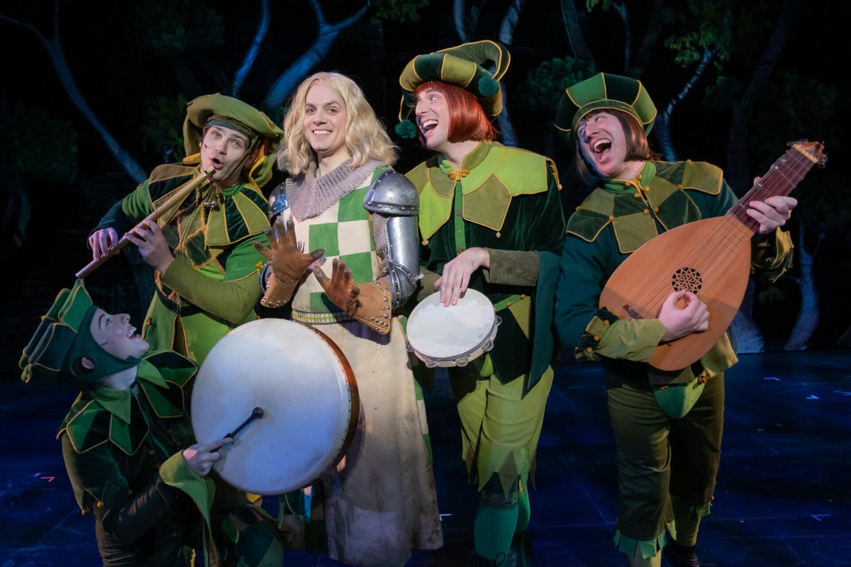 Sir Robin surrounded by his minstrels in green jester costumes