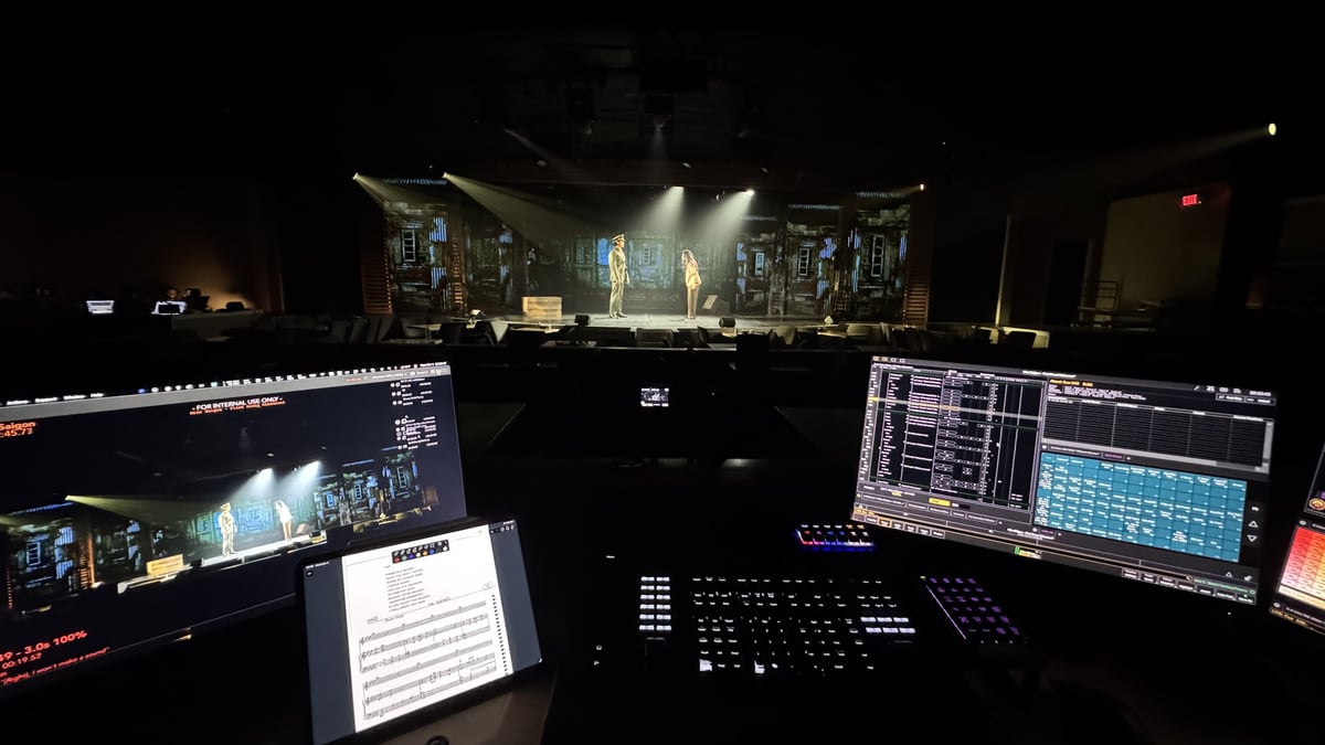 The Miss Saigon set lit onstage, seen from the Eos console at the tech table.