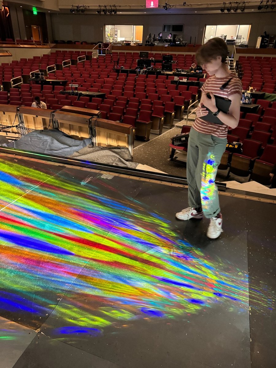 A focus session with a rainbow gobo wash spilling across the stage floor.