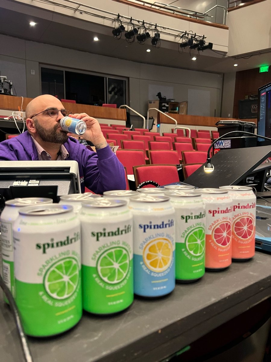 A break at the tech table behind a row of Spindrift cans.