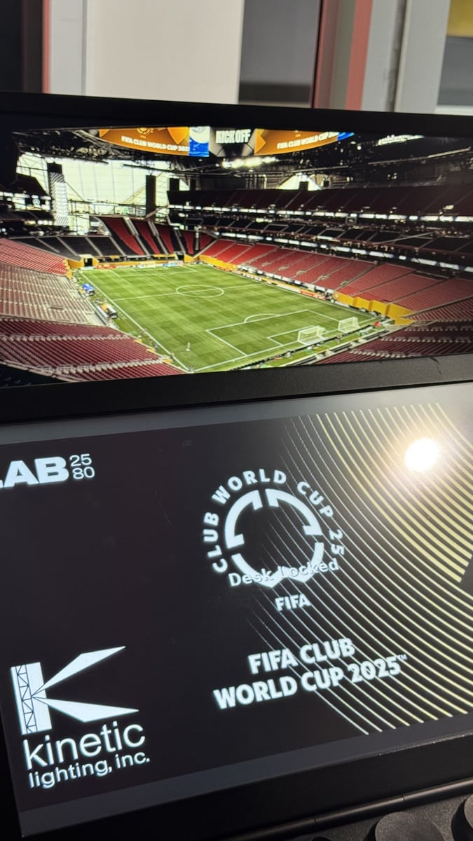 A monitor overlooking the empty Mercedes-Benz Stadium pitch set for the FIFA Club World Cup 2025, beside a Kinetic Lighting grandMA2 layout reading 'Club World Cup 25, Desk Locked'.