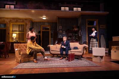 Wide view of the Younger family's Chicago apartment interior in warm naturalistic lamplight, three actors across the living room at Theatrical Outfit.
