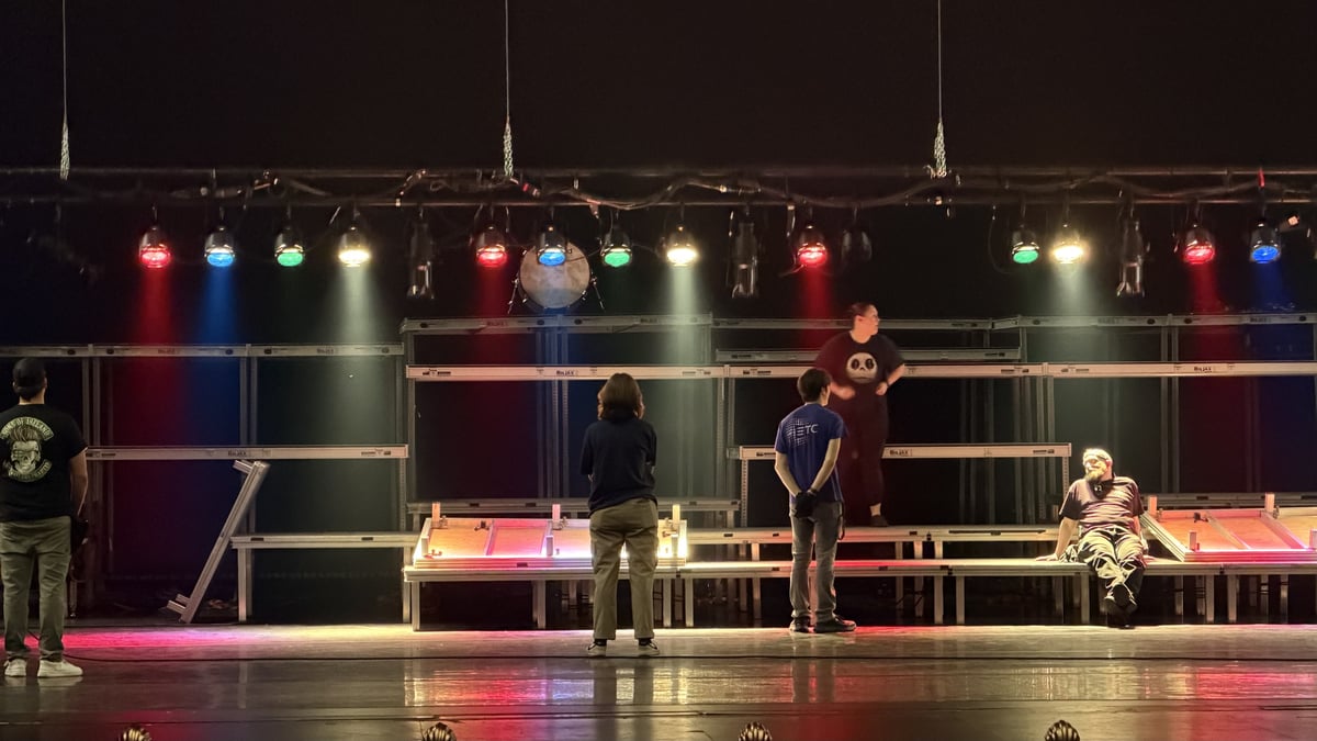 Side light washes the thrust during a performance.