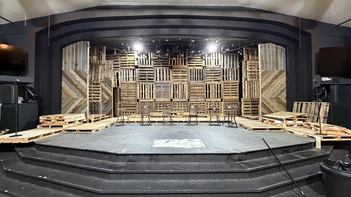 The pallet-wood set for Spring Awakening standing empty under work lights before tech