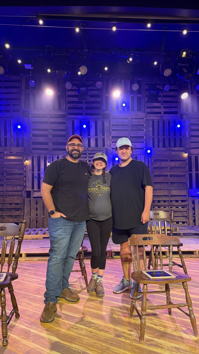 Three members of the team on the finished set under a blue wash
