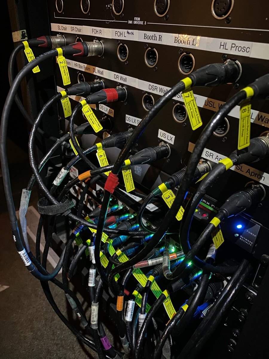 Labeled DMX and power cables patched into the dimmer rack.