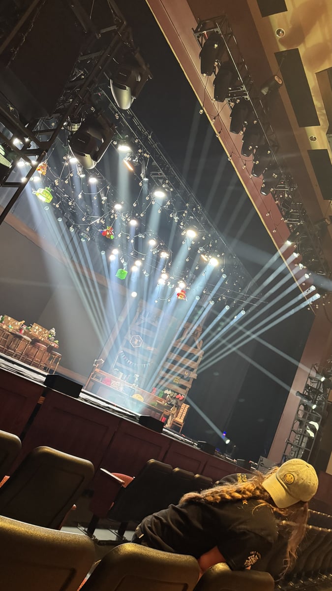 Beams cut through haze across the set in a finished cue look.