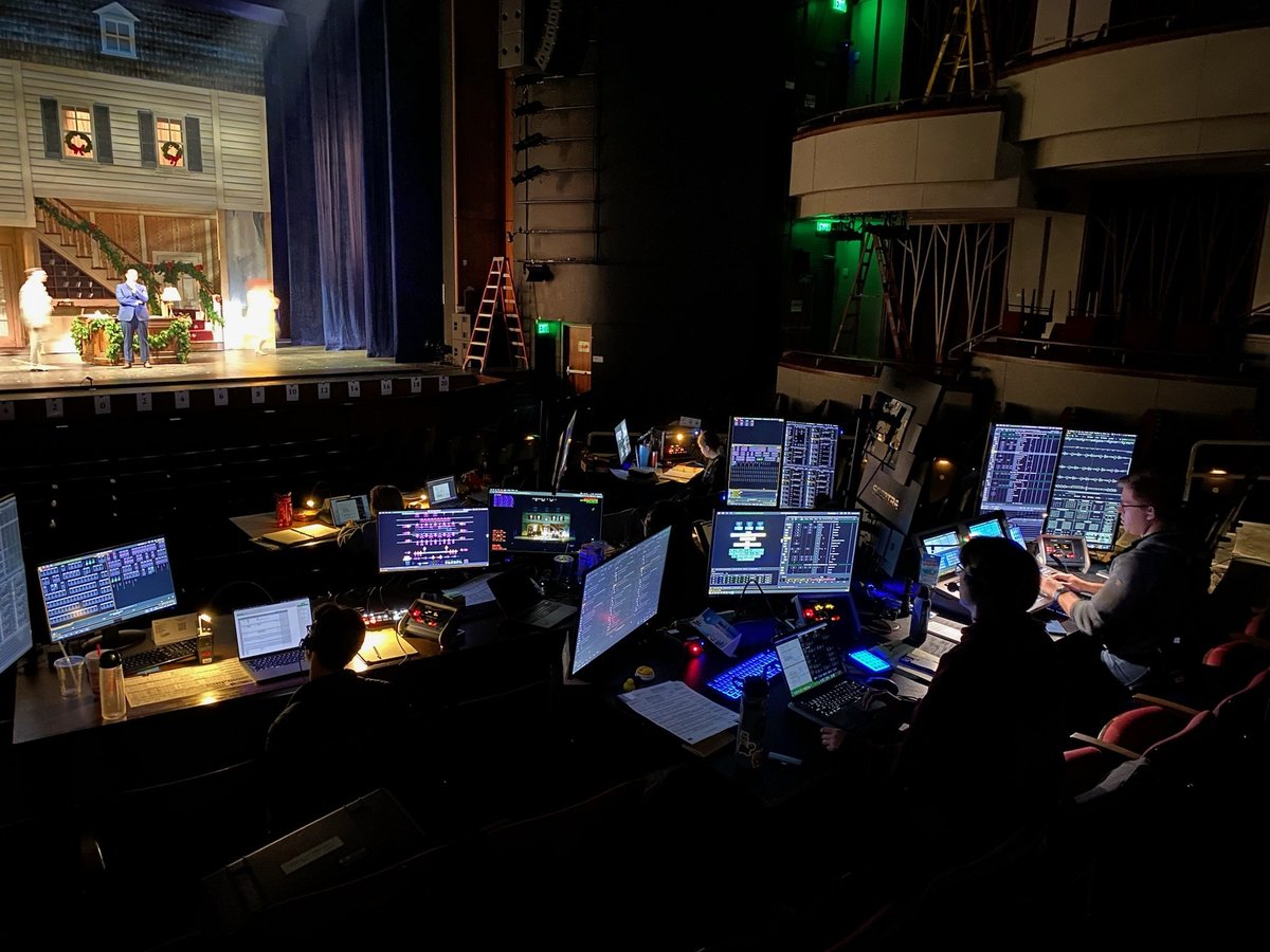 Tech tables in the house with the White Christmas inn set lit onstage.