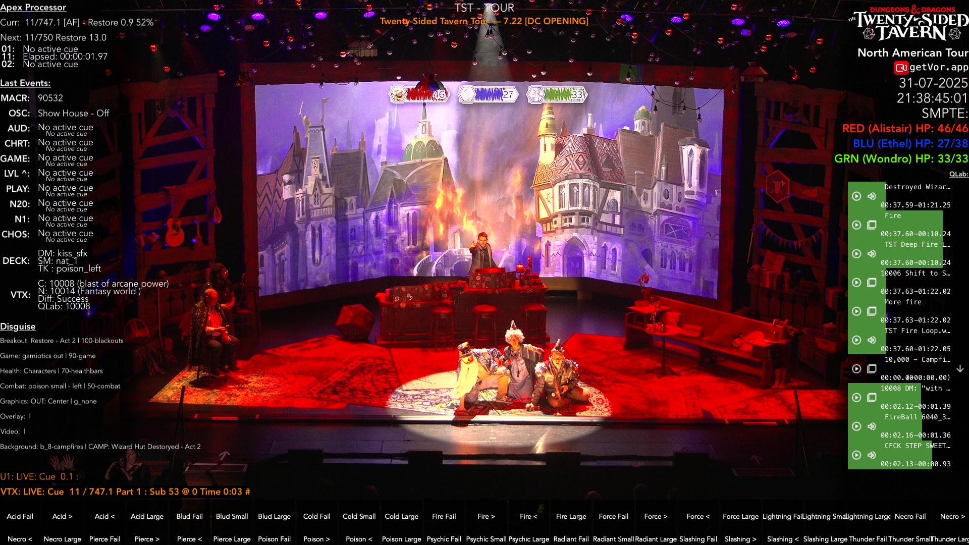 The same stage mid-show: a burning village filling the LED wall, the whole room saturated in red